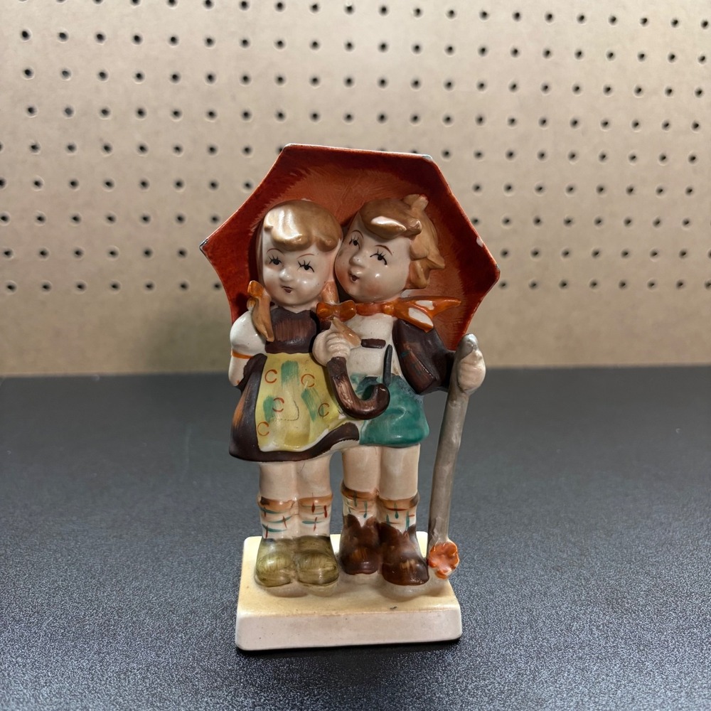 Vintage Japan Porcelain Figure of a boy and girl holding a redumbrella bow